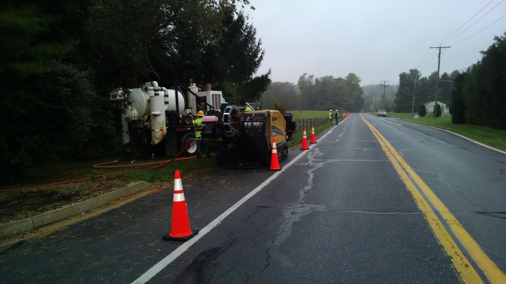 A drilling crew in Westminster, MD prepares equipment and the roadway for work